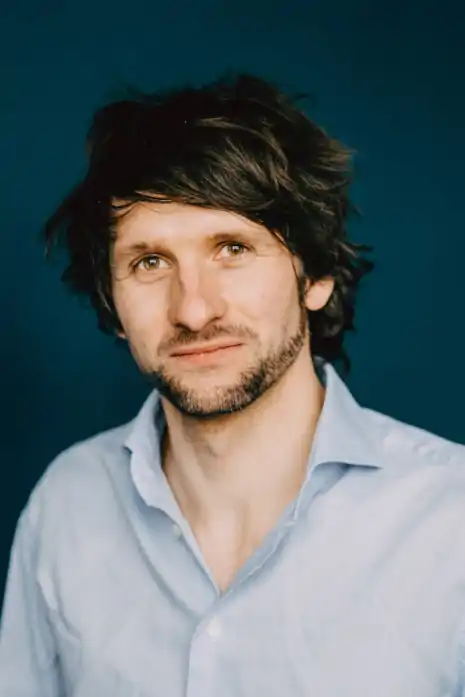 Profile picture of the awardee Thomas Dauser Profile picture of the awardee Thomas Dauser. The upper body and the head of a man with dark brown hairs and beard dressed in a light blue shirt is shown.